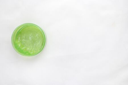 Jar of cream and flowers on white background, top view. Professional cosmetic productsの写真素材