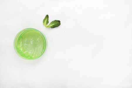 Jar of cream and flowers on white background, top view. Professional cosmetic productsの写真素材