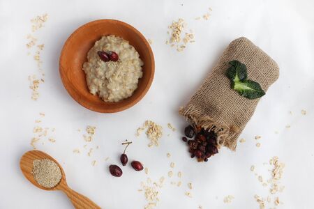 Oatmeal with butter. Healthy eating concept. View from above. dried berriesの写真素材