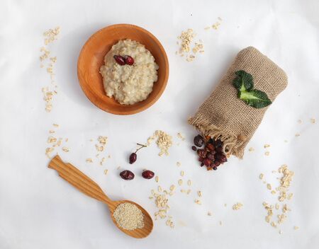 Oatmeal with butter. Healthy eating concept. View from above. dried berriesの写真素材