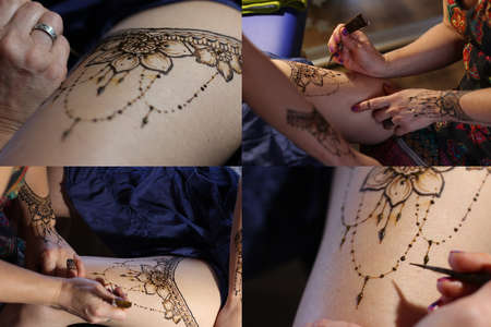 Image detail of henna being applied to hand. a lot of jewelry on the arms, bare belly. partial focus, art blur.の写真素材