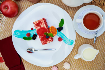 Cake Red velvet with berries on a white plateの写真素材