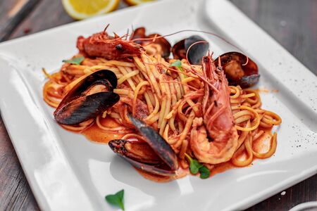 pasta with seafood, with mussels and shrimps on a wooden backgroundの写真素材