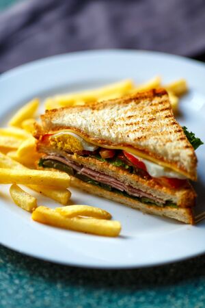 Delicious club sandwich with french fries at a diner.の写真素材
