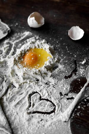flour and egg on a wooden tableの写真素材