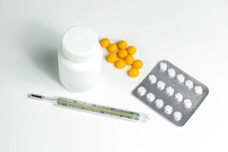 white plastic can with medicines and thermometerの写真素材