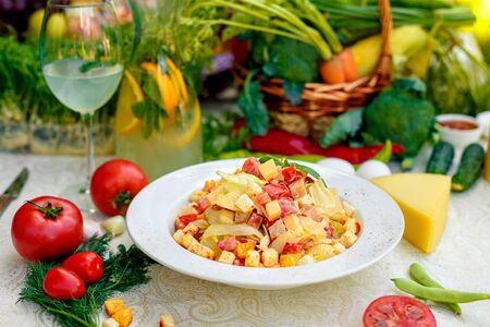 fresh salad with chicken, cheese, rusks, lettuce and tomatoesの写真素材