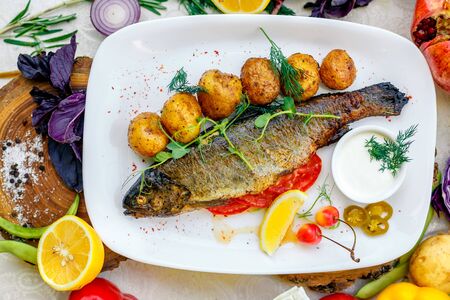 Grilled trout with potato sauce and tomato sauce and jalapenoの写真素材