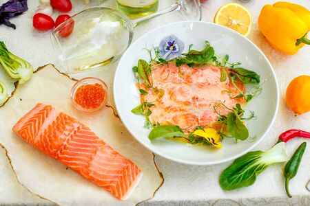 Fillet of red fish with a fresh piece of cooking with greens and vegetablesの写真素材