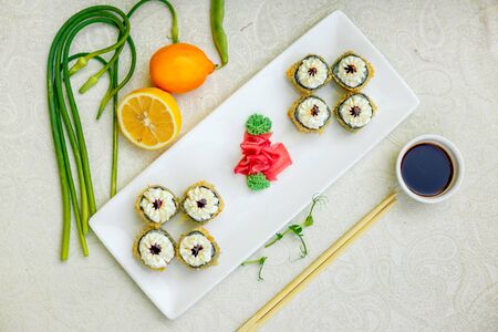fried warm sushi with wasabi and soy sauce with chopsticksの写真素材