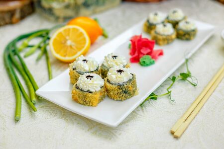 fried warm sushi with wasabi and soy sauce with chopsticksの写真素材