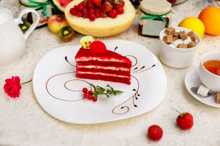 delicious red velvet cake on a chocolate-plated plateの写真素材