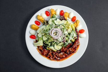 Mix of five types of lettuce (iceberg, batavia, spinach, arugula, lollo rossa) and crispy cucumbers in a dressing from Greek yogurtの写真素材