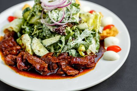 Mix of five types of lettuce (iceberg, batavia, spinach, arugula, lollo rossa) and crispy cucumbers in a dressing from Greek yogurtの写真素材