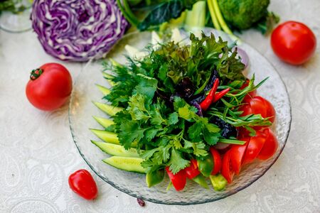 Fresh salad of tomato cucumber and pepper with greens, healthy food, vegetablesの写真素材