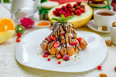 Krekembush - an elegant French profiterole cake topped with chocolate and nutsの写真素材
