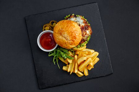 big juicy burger with french fries and ketchupの写真素材