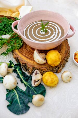 mushroom soup with vegetables and herbs on the tableの写真素材