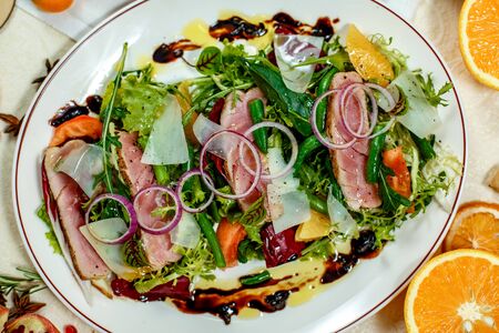 salad with smoked meat and ingredients served on the tableの写真素材