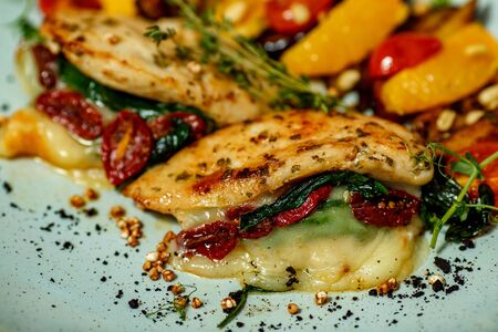 chicken breast with mashed potatoes and grilled vegetables and ingredients served on the tableの写真素材