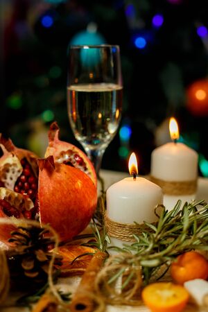 table decoration candles and a glass of champagneの写真素材