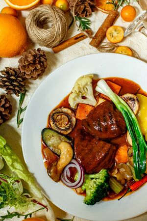 juicy steaks with grilled broccoli vegetables and mushrooms served on the tableの写真素材