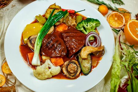 juicy steaks with grilled broccoli vegetables and mushrooms served on the tableの写真素材