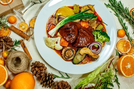 juicy steaks with grilled broccoli vegetables and mushrooms served on the tableの写真素材
