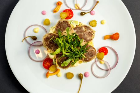 salad with meat and ingredients on a white plateの写真素材