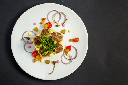 salad with meat and ingredients on a white plateの写真素材