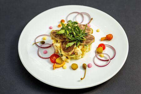 salad with meat and ingredients on a white plateの写真素材