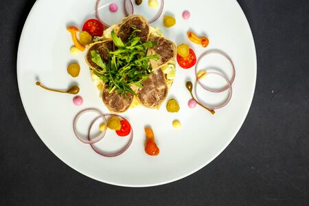 salad with meat and ingredients on a white plateの写真素材