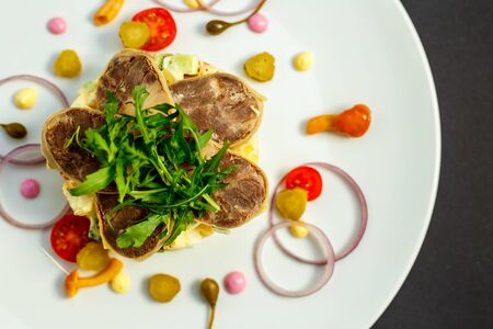 salad with meat and ingredients on a white plateの写真素材