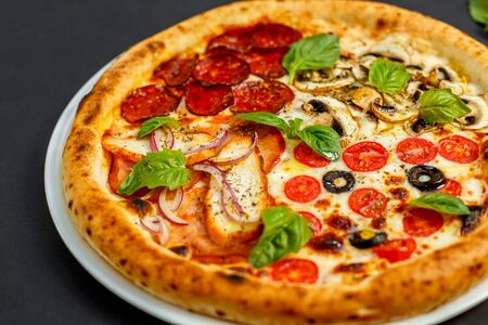 hot italian pizza with cheese and basil, isolatedの写真素材