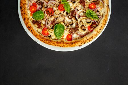 hot italian pizza with cheese and basil, isolatedの写真素材