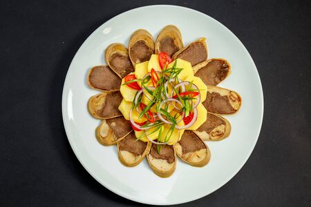 Kazakh cuisine, meat with boiled potatoes onions and herbs, on a white plateの写真素材