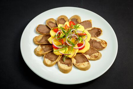 Kazakh cuisine, meat with boiled potatoes onions and herbs, on a white plateの写真素材