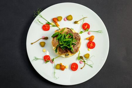 salad with meat and ingredients on a white plateの写真素材