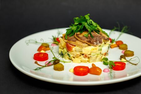 salad with meat and ingredients on a white plateの写真素材