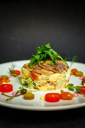 salad with meat and ingredients on a white plateの写真素材