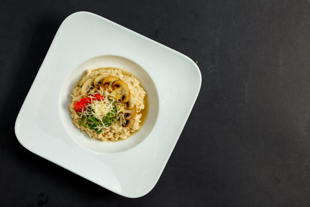 rice porridge with mushrooms, parmesan cheese, arugula and tomatoesの写真素材
