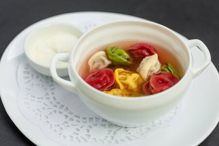 children's colored dumplings, dough made from beets, spinach and carrots by hand kneading and meat beef fillingの写真素材