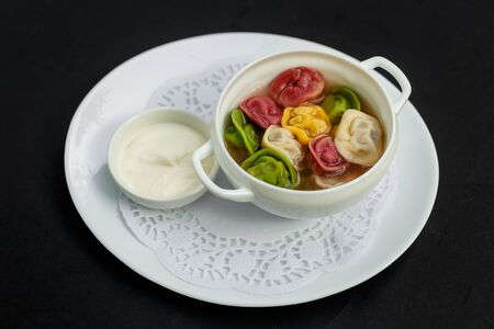 children's colored dumplings, dough made from beets, spinach and carrots by hand kneading and meat beef fillingの写真素材