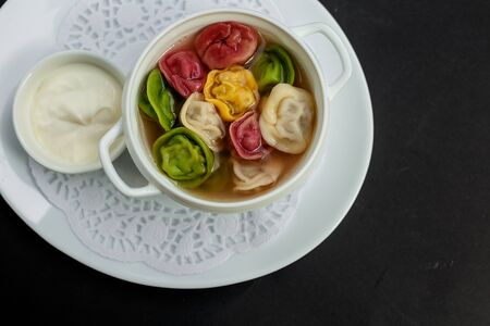 children's colored dumplings, dough made from beets, spinach and carrots by hand kneading and meat beef fillingの写真素材