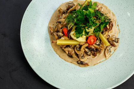 mashed potatoes with mushrooms and cream sauce with vegetablesの写真素材