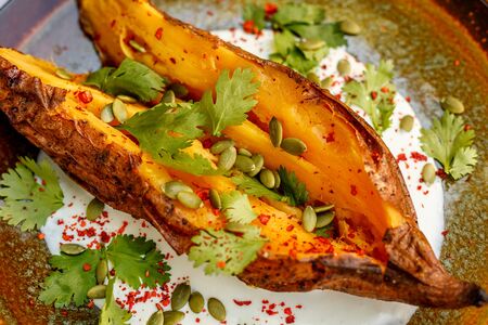 Baked Zucchini with greens and vegetables, healthy food on a decorated tableの写真素材
