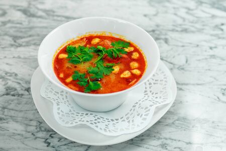 soup with chicken, mushrooms and herbs on a white plate, a beautiful servingの写真素材