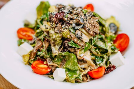 Autumn table setting with pumpkins. Thanksgiving dinner. vegetarian salad with tomatoes and cheese. Healthy foodの写真素材