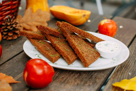 Autumn table setting with pumpkins. Thanksgiving dinner. garlic bread with sauce and herbsの写真素材