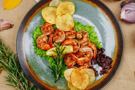 Autumn table setting with pumpkins. Thanksgiving dinner. beer shrimp with homemade potato chipsの写真素材